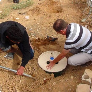 20161116   2 Eng. Nabeeh showing community member the steps of planting