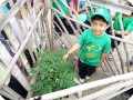 2. A student next to his planted tree  